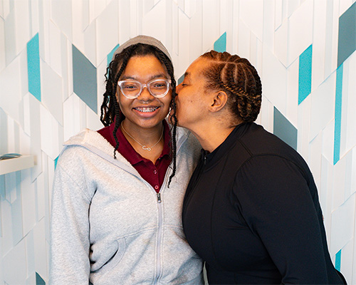 teen hugging mother happy about the braces treatment