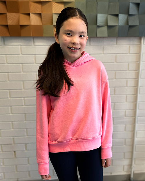 young child smiling showing off their braces from quest orthodontics